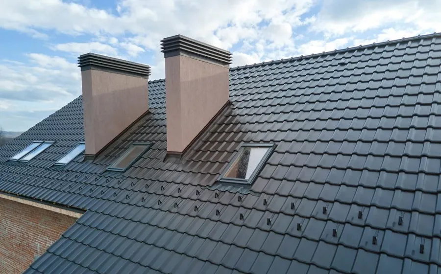 A restored tile roof under a clear sky